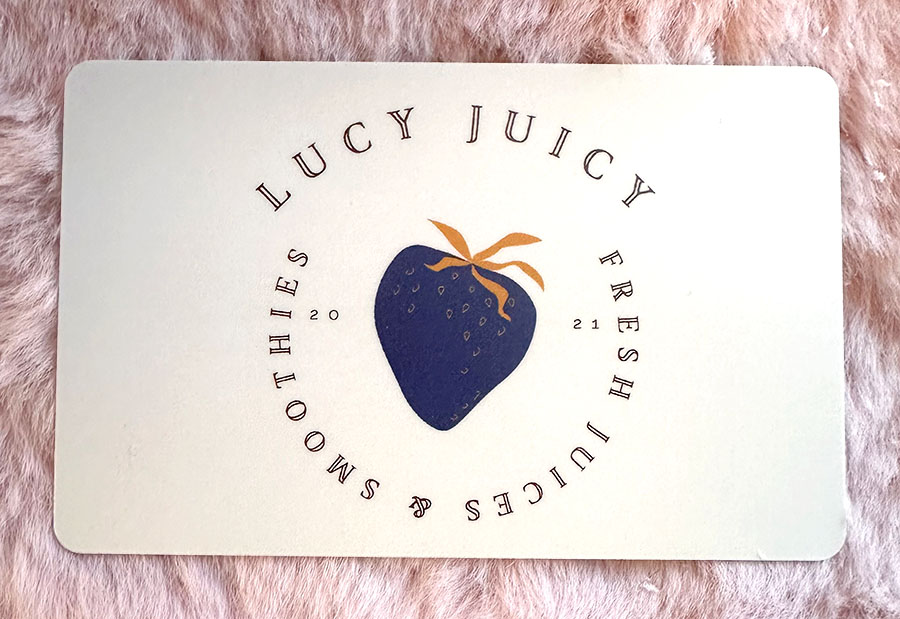 physical gift card on fluffy mauve surface